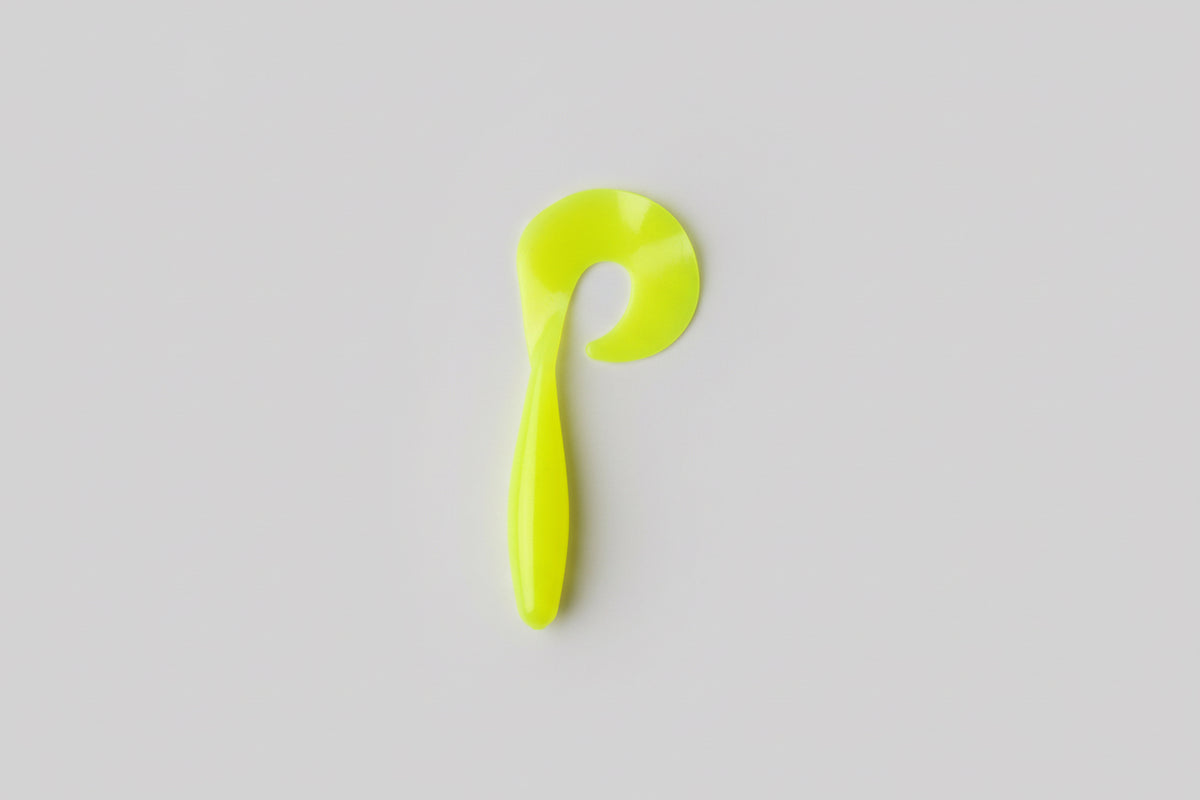 Yellow plastic hook on a white paper background