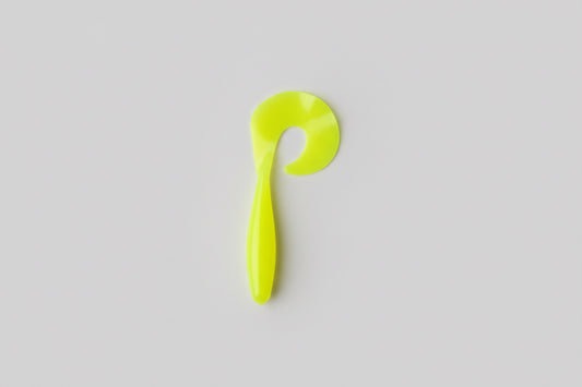 Yellow plastic hook on a white paper background